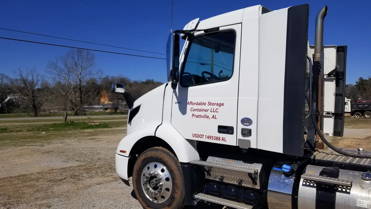 Affordable Storage Containers branded delivery truck at the company yard in Prattville, Alabama